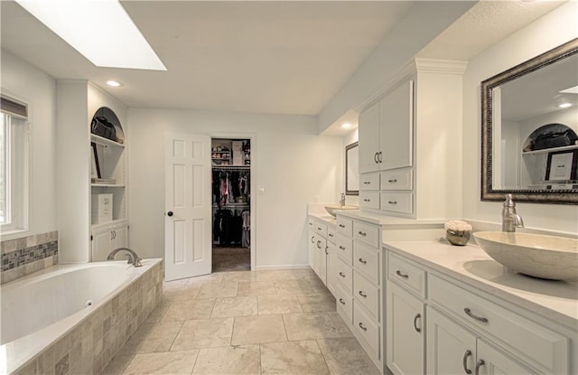 12600 Mohawk Ln, Leawood, KS 66209 - full bath with double vanity, a skylight, a garden tub, a spacious closet, and recessed lighting