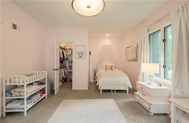 12600 Mohawk Ln, Leawood, KS 66209 - bedroom featuring multiple windows, carpet flooring, a walk in closet, and a closet