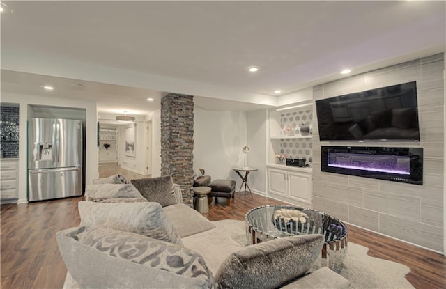 12600 Mohawk Ln, Leawood, KS 66209 - living room with recessed lighting, dark wood-style floors, a glass covered fireplace, and built in shelves