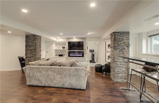 12600 Mohawk Ln, Leawood, KS 66209 - living room with decorative columns, a glass covered fireplace, dark wood finished floors, and recessed lighting