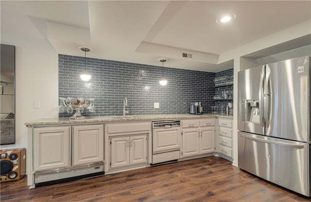 12600 Mohawk Ln, Leawood, KS 66209 - kitchen with stainless steel fridge with ice dispenser, paneled dishwasher, tasteful backsplash, light stone counters, and white cabinetry