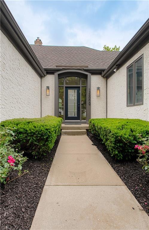 12600 Mohawk Ln, Leawood, KS 66209 - entrance to property featuring stucco siding and roof with shingles