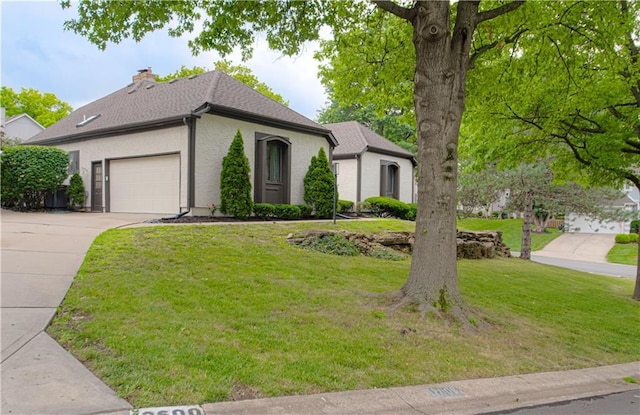 12600 Mohawk Ln, Leawood, KS 66209 - view of front of home featuring concrete driveway, a garage, a front lawn, a chimney, and stucco siding
