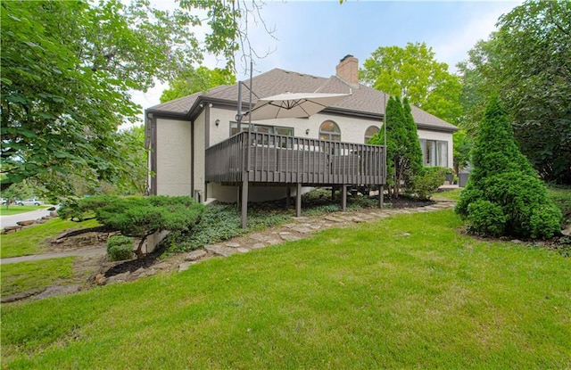 12600 Mohawk Ln, Leawood, KS 66209 - back of house featuring a yard, a wooden deck, and a chimney