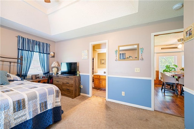 203 Scout St, Camden Point, MO 64018 - bedroom featuring light colored carpet, ensuite bath, a textured ceiling, and a raised ceiling