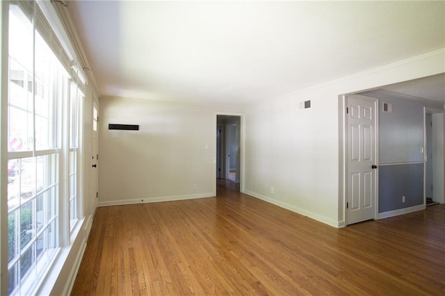 7236 Roe Ave, Prairie Village, KS 66208 - empty room with wood finished floors and ornamental molding