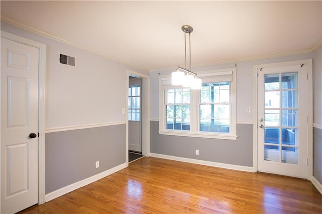 7236 Roe Ave, Prairie Village, KS 66208 - unfurnished dining area with light wood finished floors and crown molding