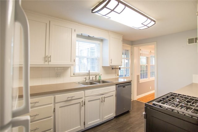 7236 Roe Ave, Prairie Village, KS 66208 - kitchen with freestanding refrigerator, dishwasher, black gas range oven, tasteful backsplash, and light countertops