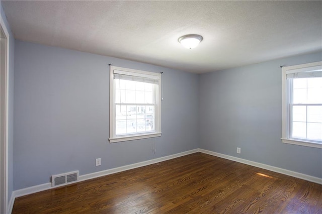 7236 Roe Ave, Prairie Village, KS 66208 - spare room featuring dark wood-style flooring and baseboards
