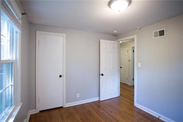 7236 Roe Ave, Prairie Village, KS 66208 - unfurnished bedroom featuring dark wood-style flooring and a closet