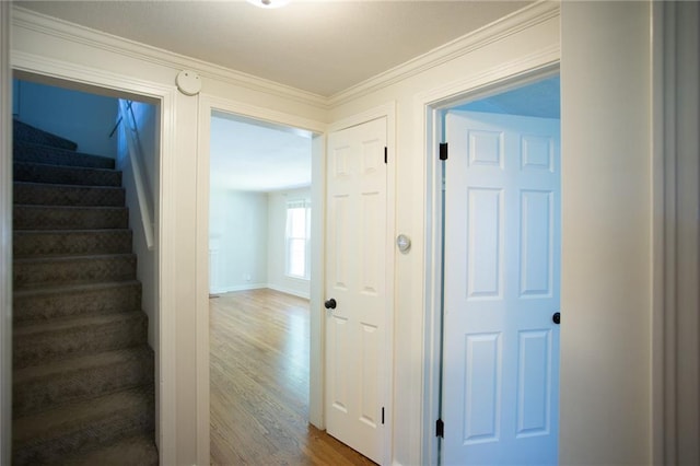 7236 Roe Ave, Prairie Village, KS 66208 - hall featuring stairway, wood finished floors, and ornamental molding