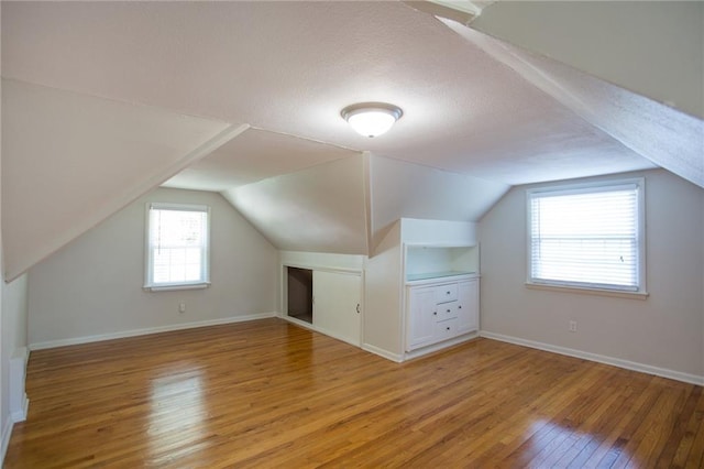 7236 Roe Ave, Prairie Village, KS 66208 - bonus room with light wood-type flooring, vaulted ceiling, and a textured ceiling