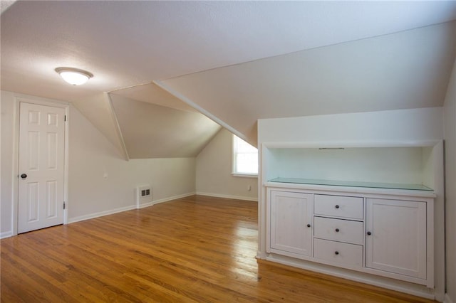 7236 Roe Ave, Prairie Village, KS 66208 - additional living space featuring light wood-type flooring and vaulted ceiling
