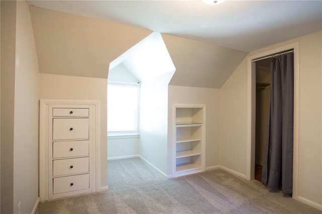 7236 Roe Ave, Prairie Village, KS 66208 - bonus room with built in shelves, carpet flooring, and vaulted ceiling