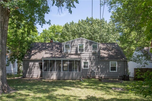 7236 Roe Ave, Prairie Village, KS 66208 - back of property featuring a sunroom, a yard, a chimney, and a shingled roof