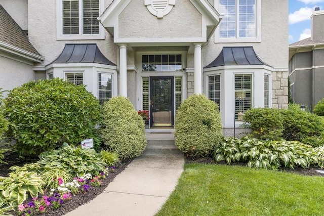 5125 W 164th St, Overland Park, KS 66085 - doorway to property featuring a standing seam roof, stucco siding, and a metal roof