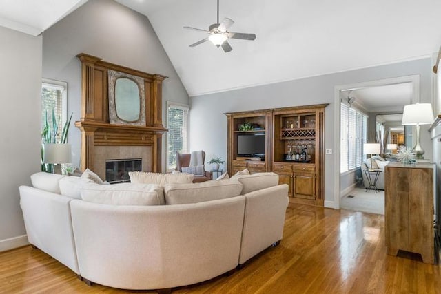 5125 W 164th St, Overland Park, KS 66085 - living room with a tiled fireplace, ceiling fan, light wood finished floors, plenty of natural light, and lofted ceiling