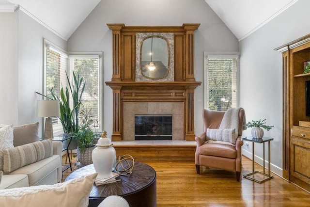 5125 W 164th St, Overland Park, KS 66085 - living area with vaulted ceiling, a fireplace, wood finished floors, and crown molding