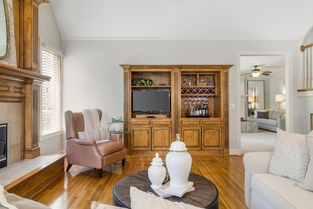 5125 W 164th St, Overland Park, KS 66085 - living area featuring light wood-style flooring, a ceiling fan, lofted ceiling, and a tile fireplace