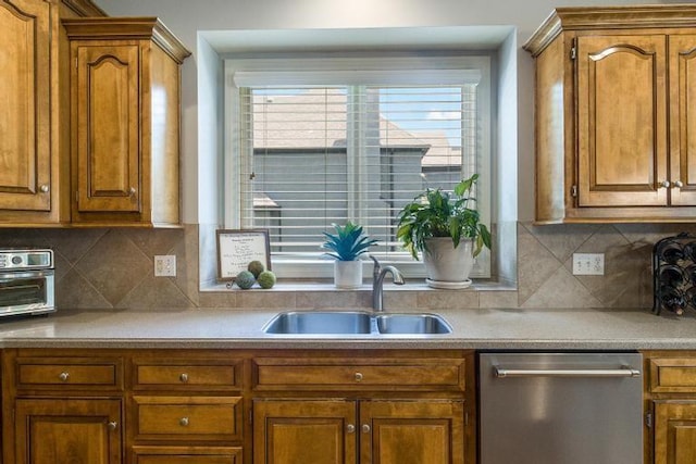 5125 W 164th St, Overland Park, KS 66085 - kitchen with stainless steel dishwasher, brown cabinetry, decorative backsplash, and light countertops