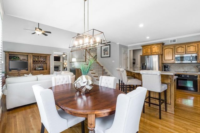 5125 W 164th St, Overland Park, KS 66085 - dining room featuring ceiling fan, stairs, light wood-style floors, a chandelier, and recessed lighting