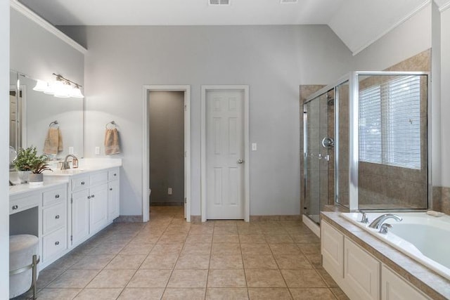 5125 W 164th St, Overland Park, KS 66085 - bathroom with vanity, a garden tub, vaulted ceiling, a shower stall, and tile patterned floors