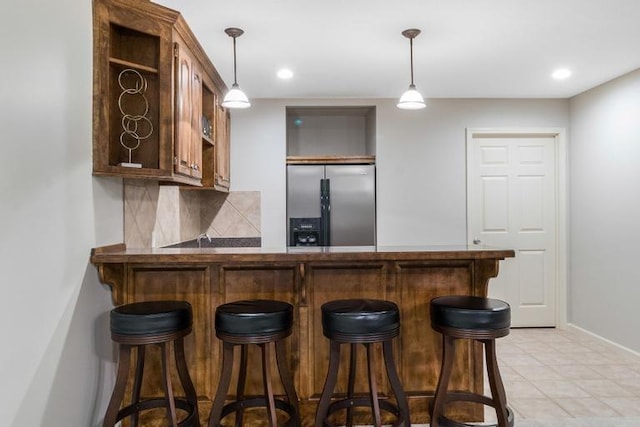 5125 W 164th St, Overland Park, KS 66085 - indoor dry bar featuring stainless steel fridge, backsplash, decorative light fixtures, and recessed lighting