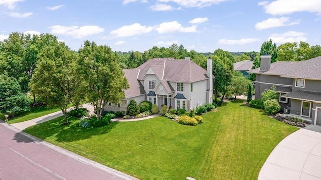 5125 W 164th St, Overland Park, KS 66085 - view of front of house featuring a front yard and a chimney