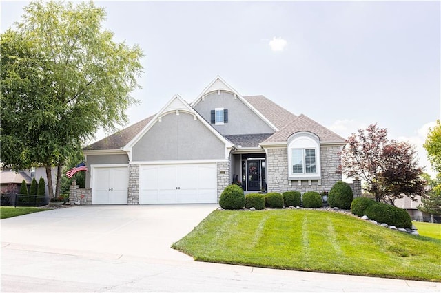 4500 Parks Summit Ter, Lees Summit, MO 64064 - french country inspired facade with an attached garage, stone siding, a front lawn, and driveway