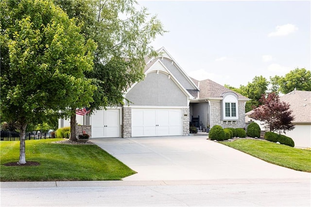 4500 Parks Summit Ter, Lees Summit, MO 64064 - view of front facade featuring a garage, stone siding, driveway, a front yard, and stucco siding