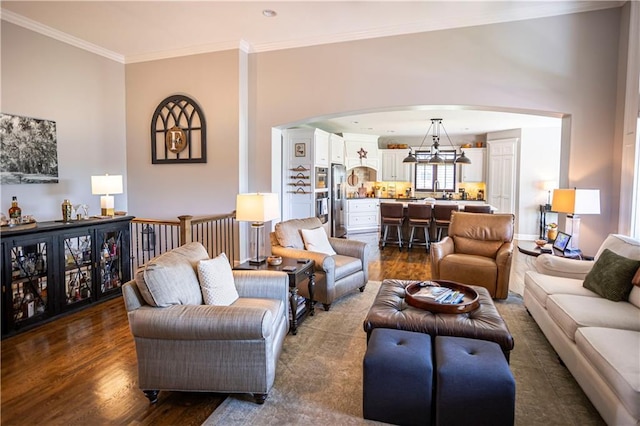 4500 Parks Summit Ter, Lees Summit, MO 64064 - living area featuring arched walkways, dark wood finished floors, ornamental molding, and a chandelier