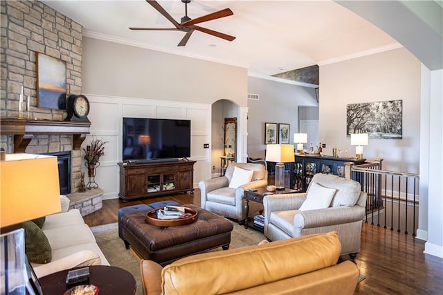 4500 Parks Summit Ter, Lees Summit, MO 64064 - living room with arched walkways, a ceiling fan, crown molding, wood finished floors, and a stone fireplace