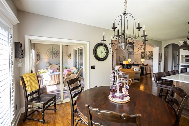 4500 Parks Summit Ter, Lees Summit, MO 64064 - dining area featuring wood finished floors, a chandelier, and arched walkways