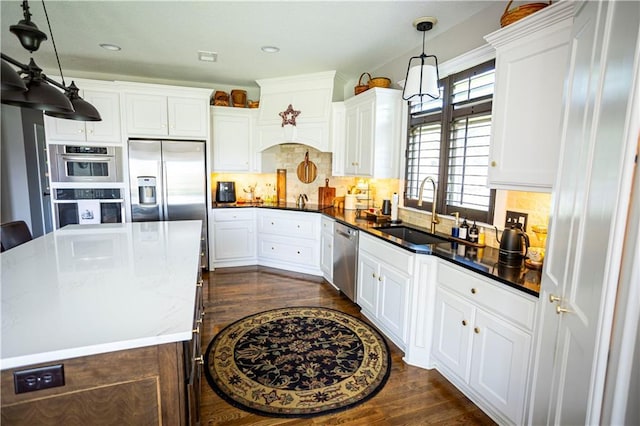 4500 Parks Summit Ter, Lees Summit, MO 64064 - kitchen with stainless steel appliances, dark wood finished floors, white cabinetry, hanging light fixtures, and recessed lighting
