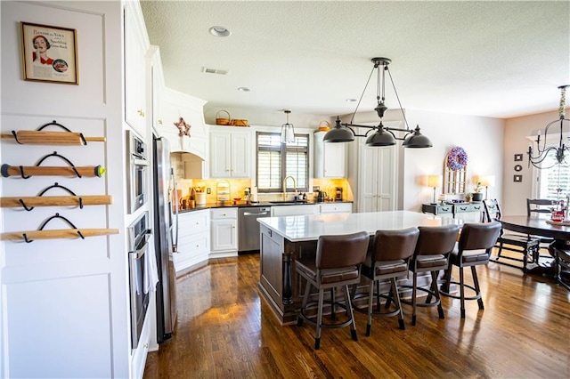4500 Parks Summit Ter, Lees Summit, MO 64064 - kitchen with stainless steel appliances, healthy amount of natural light, decorative backsplash, a kitchen breakfast bar, and recessed lighting
