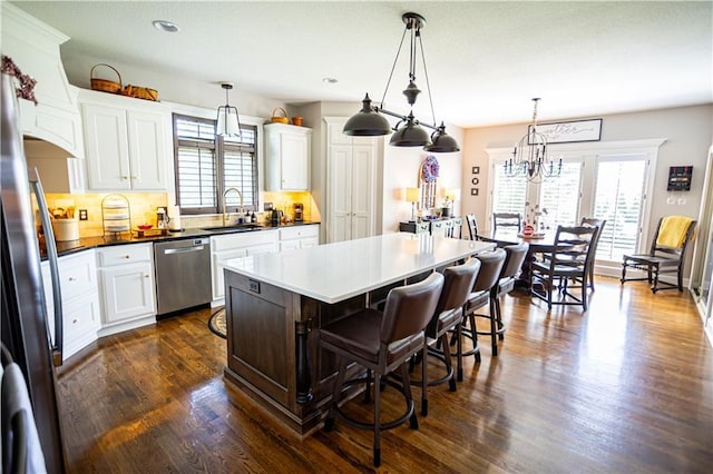 4500 Parks Summit Ter, Lees Summit, MO 64064 - kitchen with appliances with stainless steel finishes, plenty of natural light, dark wood finished floors, a kitchen breakfast bar, and recessed lighting