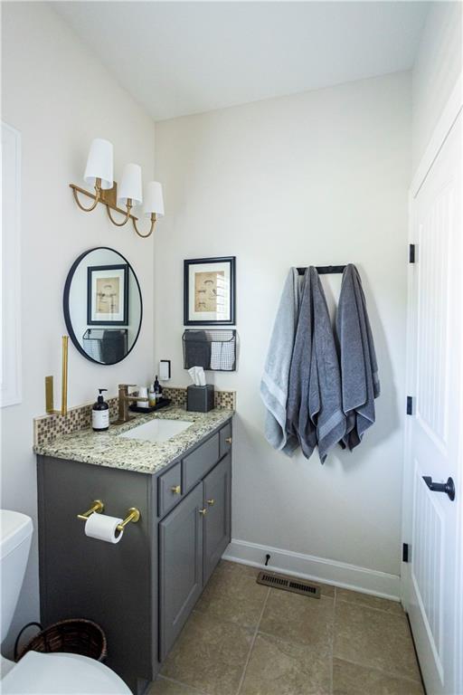 4500 Parks Summit Ter, Lees Summit, MO 64064 - half bath featuring vanity, a chandelier, and tile patterned floors