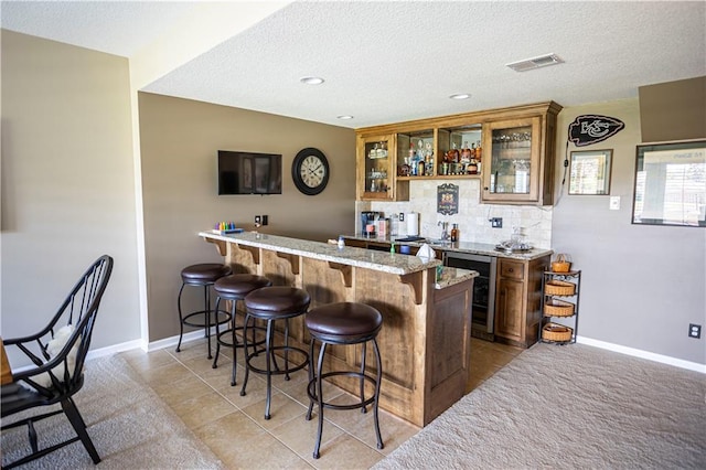 4500 Parks Summit Ter, Lees Summit, MO 64064 - indoor wet bar featuring beverage cooler, backsplash, light tile patterned floors, a textured ceiling, and recessed lighting