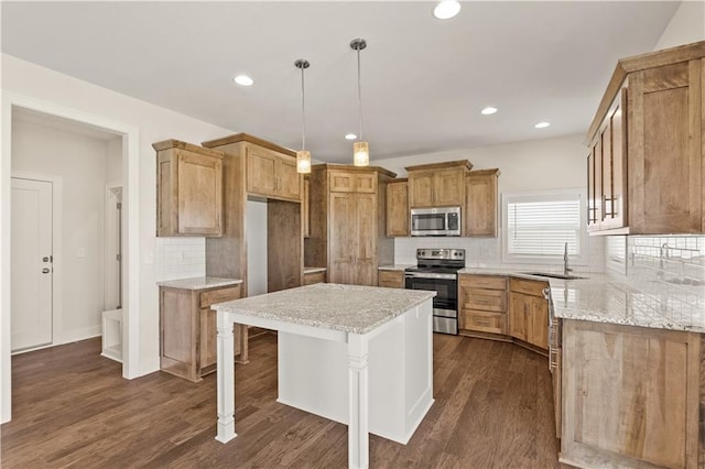 28400 W 161st Ter, Gardner, KS 66030 - kitchen with appliances with stainless steel finishes, backsplash, dark wood finished floors, light stone counters, and recessed lighting