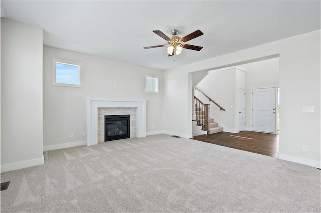 28400 W 161st Ter, Gardner, KS 66030 - unfurnished living room featuring stairway, carpet flooring, ceiling fan, and a glass covered fireplace