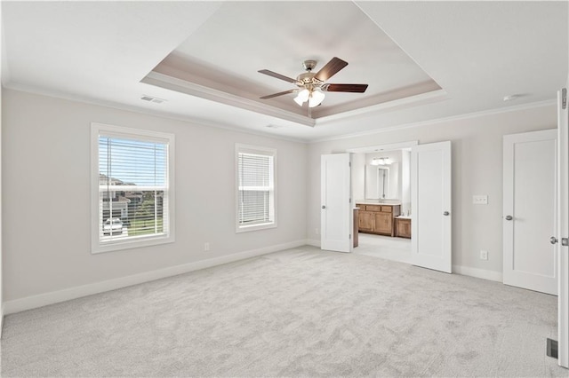 28400 W 161st Ter, Gardner, KS 66030 - unfurnished bedroom featuring a raised ceiling, ornamental molding, light colored carpet, connected bathroom, and ceiling fan