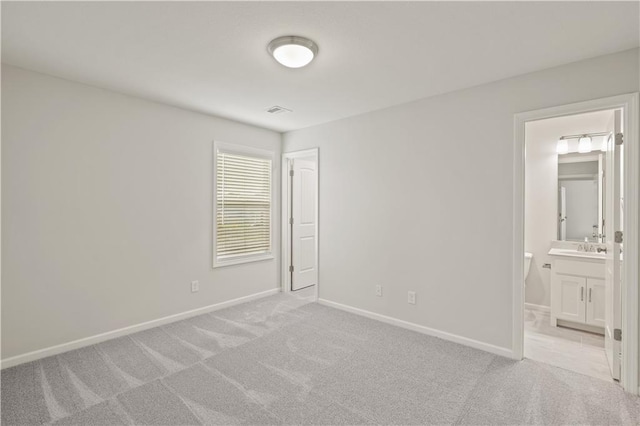 28501 W 161st Ter, Gardner, KS 66030 - unfurnished bedroom featuring light carpet and ensuite bathroom
