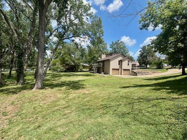 6960 Dancaster Rd, Topeka, KS 66610 - view of grassy yard featuring a garage