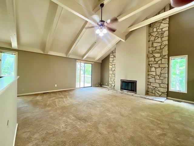 6960 Dancaster Rd, Topeka, KS 66610 - unfurnished living room featuring beam ceiling, ceiling fan, a stone fireplace, carpet, and high vaulted ceiling