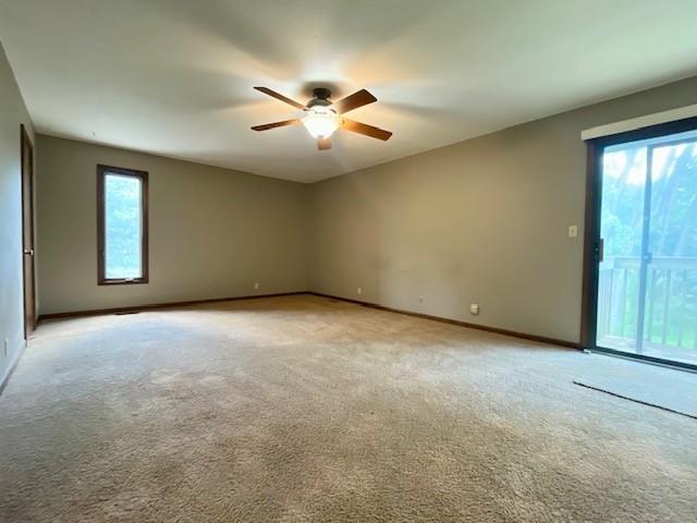 6960 Dancaster Rd, Topeka, KS 66610 - spare room featuring ceiling fan, plenty of natural light, and light carpet
