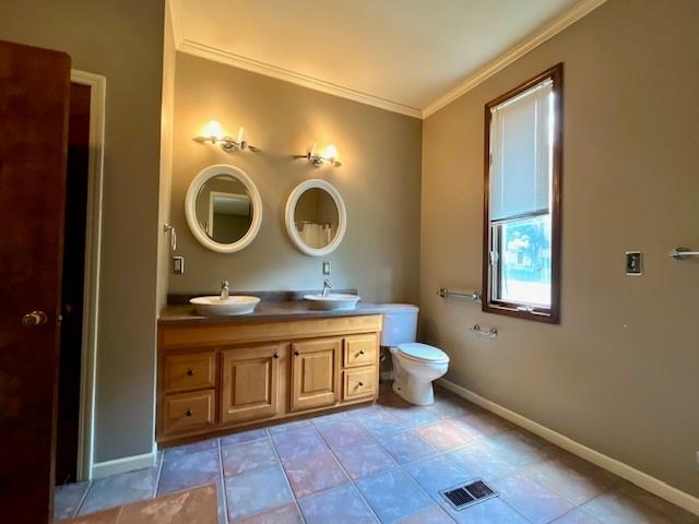 6960 Dancaster Rd, Topeka, KS 66610 - full bath featuring crown molding, double vanity, and tile patterned flooring