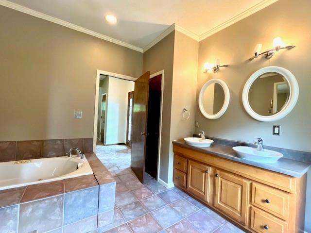 6960 Dancaster Rd, Topeka, KS 66610 - full bathroom with double vanity, a garden tub, and crown molding