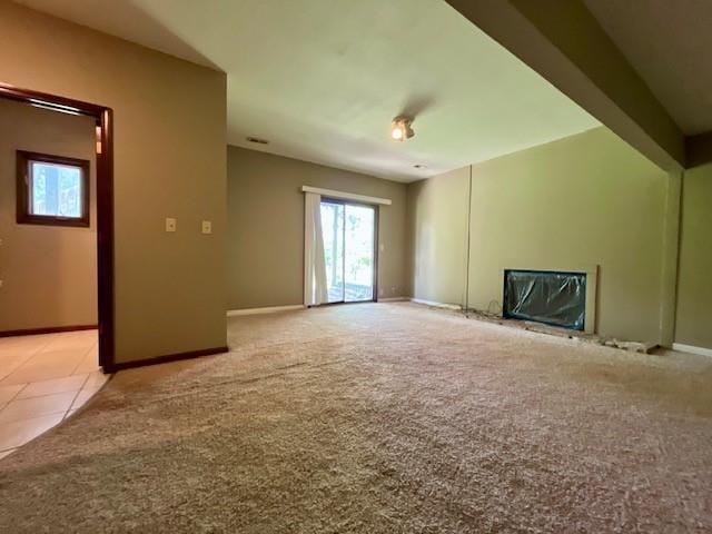6960 Dancaster Rd, Topeka, KS 66610 - unfurnished living room featuring plenty of natural light and light colored carpet