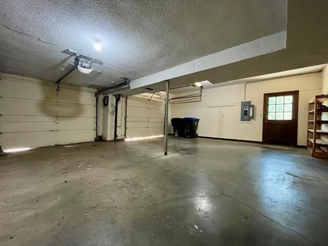 6960 Dancaster Rd, Topeka, KS 66610 - garage with electric panel and a garage door opener