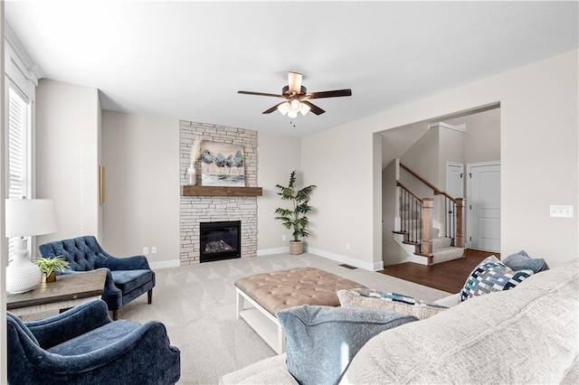 28225 W 162nd Ter, Gardner, KS 66030 - carpeted living area with stairway, ceiling fan, and a stone fireplace